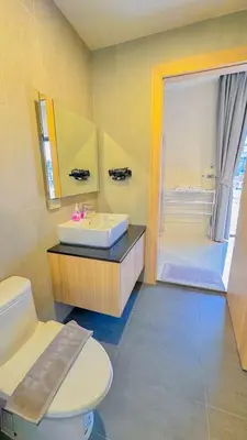 a bathroom with a toilet and a sink and a shower at The Memories Hill Phuket in Thalang