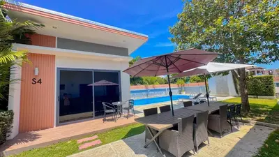 a patio with a table and umbrella and a pool at The Memories Hill Phuket in Thalang