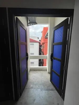 an open door to a balcony with a view of a city at Islanda Hotel Patong in Patong Beach