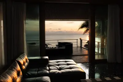 a living room with a couch and a view of the ocean at Villa Serenity pool SeaView 6BR in Kamala Beach