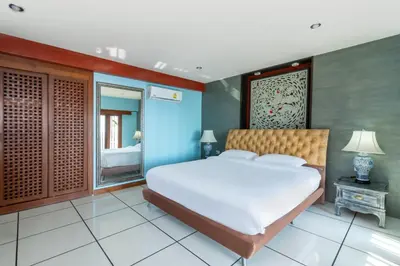 a bedroom with a large white bed and a mirror at Villa Serenity pool SeaView 6BR in Kamala Beach