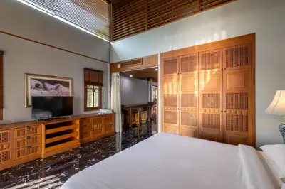 a bedroom with a bed and a flat screen tv at Villa Serenity pool SeaView 6BR in Kamala Beach