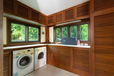 a laundry room with a washer and dryer and windows at Villa Serenity pool SeaView 6BR in Kamala Beach