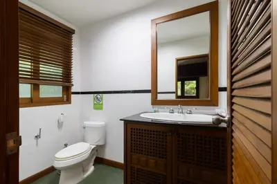 a bathroom with a toilet and a sink and a mirror at Villa Serenity pool SeaView 6BR in Kamala Beach