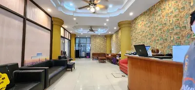 a lobby of a restaurant with a bar and chairs at Royal Sweet Hotel in Patong Beach
