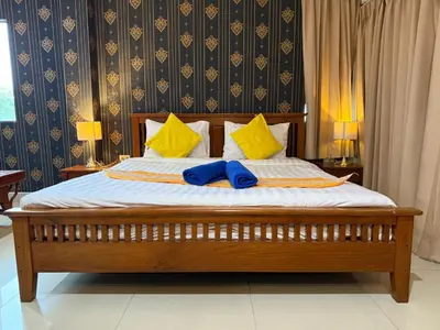 a bed with two blue towels on top of it at Royal Sweet Hotel in Patong Beach