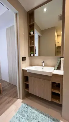 a bathroom with a sink and a mirror at 1 Bedroom Sky Park corner in Bang Tao Beach