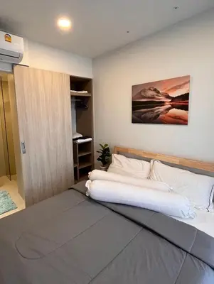 a bedroom with a large bed with a white mattress at 1 Bedroom Sky Park corner in Bang Tao Beach