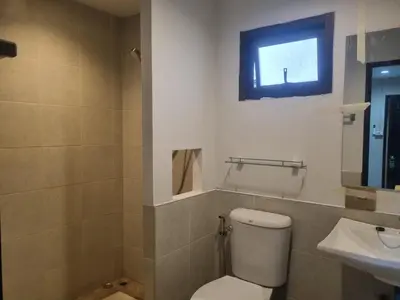 a bathroom with a toilet and a sink at New Breakers Hotel Rawai in Rawai Beach