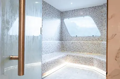 a bathroom with a bath tub with a window at Sole Mio Boutique Hotel and Wellness - Adults Only in Bang Tao Beach