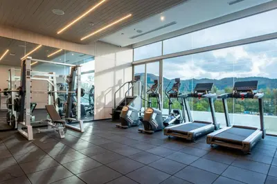 a gym with treadmills and cardio equipment in a building at Sole Mio Boutique Hotel and Wellness - Adults Only in Bang Tao Beach