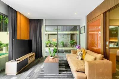 a living room with a couch and a tv at Villa Pattara Rawai in Ban Saiyuan (1)