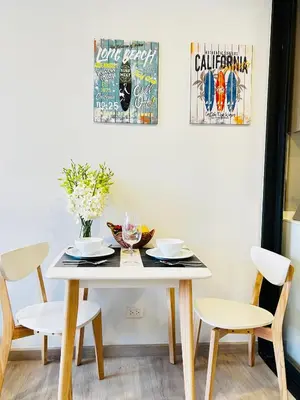 a dining room table with two chairs and a white table at 1 Bdr Sky Park Golf view in Bang Tao Beach