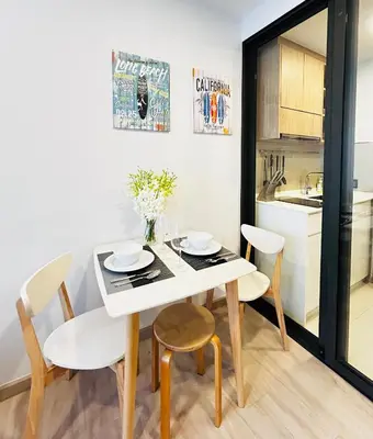 a kitchen and dining room with a white table and chairs at 1 Bdr Sky Park Golf view in Bang Tao Beach