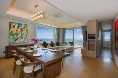 a living room with a table and chairs and a couch at Chic Design & Full Seaview 2BR Karon Condo 16C, near Beach in Karon Beach