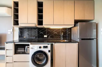 a kitchen with a washer and a dishwasher at Deluxe apartment with sea view and jacuzzi in Surin Beach