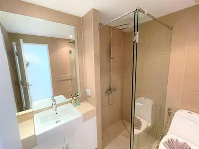 a bathroom with a shower and a sink and a toilet at Spacious apartment at Kata Ocean View M11 in Kata Beach