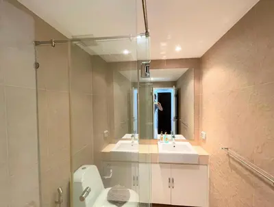 a bathroom with a toilet and a sink and a mirror at Spacious apartment at Kata Ocean View M11 in Kata Beach