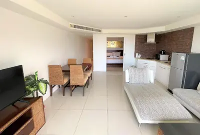 a kitchen and living room with a table and chairs at Spacious apartment at Kata Ocean View M11 in Kata Beach