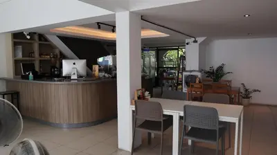 a restaurant with a counter and a table and chairs at Patong Triple P in Patong Beach