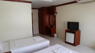 a room with a bed and a flat screen tv at Patong Triple P in Patong Beach