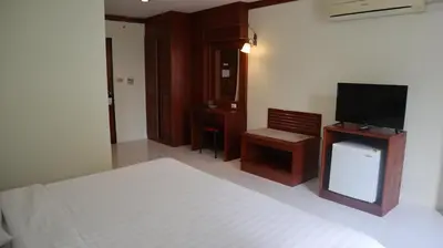 a bedroom with a bed and a flat screen tv at Patong Triple P in Patong Beach