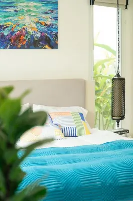 a bedroom with a bed with a painting on the wall at Kamala Garden View Villa 3 Bdr in Kamala Beach