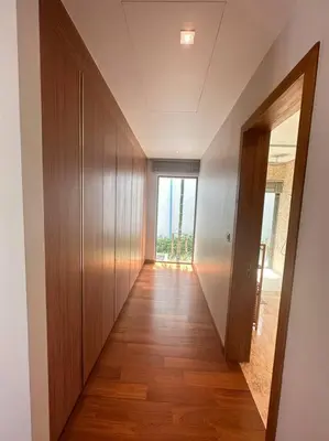 a hallway with wooden floors and a large window at Private pool villa 3 Bed, 3 Bath near airport in Phuket Town