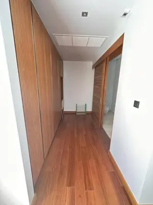 an empty hallway with wooden doors and a wooden floor at Private pool villa 3 Bed, 3 Bath near airport in Phuket Town