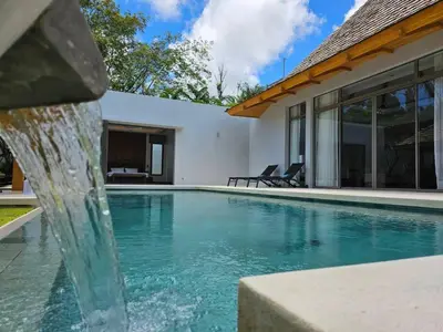 a swimming pool with a fountain in front of a house at Private pool villa 3 Bed, 3 Bath near airport in Phuket Town