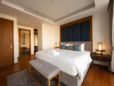 a bedroom with a large white bed and a large window at ANGSANA Beachfront Residences apartment with pool in Laguna Phuket in Bang Tao Beach