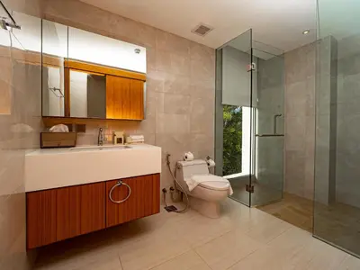 a bathroom with a toilet and a sink and a shower at ANGSANA Beachfront Residences apartment with pool in Laguna Phuket in Bang Tao Beach