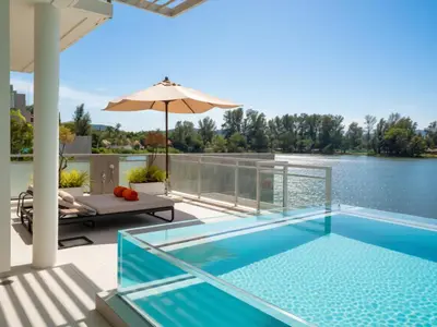 a swimming pool on the deck of a house at ANGSANA Beachfront Residences apartment with pool in Laguna Phuket in Bang Tao Beach