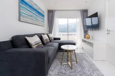a living room with a couch and a table at Patong Tower 1-Bedroom , 200 meters from the Beach in Patong Beach