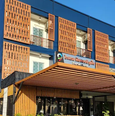 a building with a store with a sign on it at Pinpoint Hotel Phuket in Ban Pak Lak