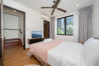 a bedroom with a white bed and a window at 3BDR Townhouse in Laguna Park in Bang Tao Beach