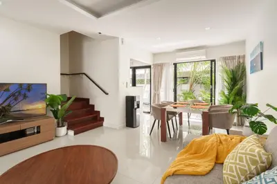 a living room with a table and a dining room at 3BDR Townhouse in Laguna Park in Bang Tao Beach
