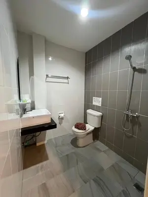 a bathroom with a toilet and a sink and a shower at Kata Noi Bay Inn in Kata Beach