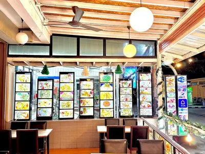a restaurant with plates of food on the wall at Kata Noi Bay Inn in Kata Beach