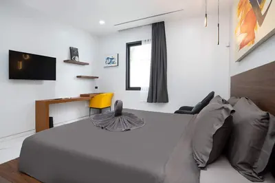 a bedroom with a white bed and a couch at Villa Brianna Luxuria 4 - Rawai in Rawai Beach