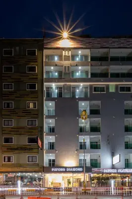 a tall building with a light on top of it at Patong Diamond Hotel in Patong Beach