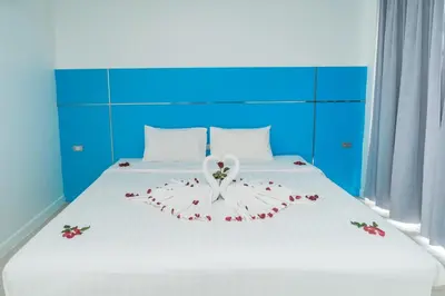 a bedroom with a bed with flowers on it at Patong Diamond Hotel in Patong Beach
