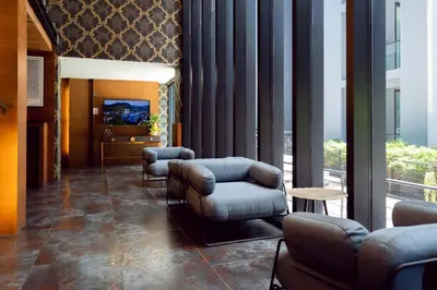 a waiting room with couches and chairs in a building at Modern Urban Living Kamala in Kamala Beach