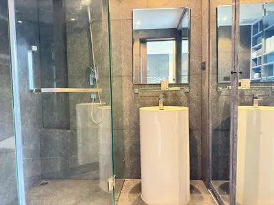 a bathroom with two toilets and a glass shower at Modern Urban Living Kamala in Kamala Beach