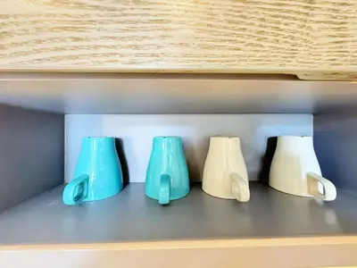 four blue and white vases sitting on a shelf at Modern Urban Living Kamala in Kamala Beach