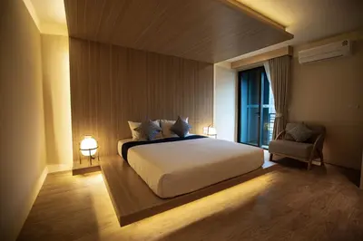 a bedroom with a large white bed and a window at The Arch Phuket Hotel in Ban Ket Ho