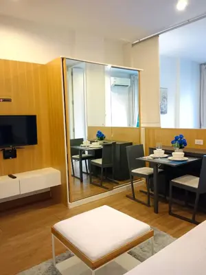 a dining room with a mirror and tables and chairs at Hill Myna Condotel by Bcare - One Bedroom in Ban Thalat Choeng Thale