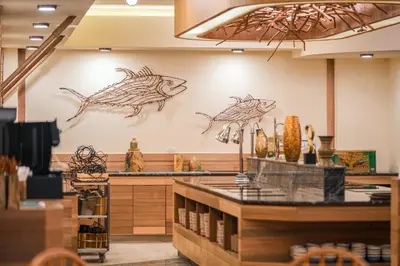 a restaurant with two fish on the wall at The Marin Phuket Kamala Beach in Kamala Beach