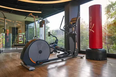 a gym with a exercise bike and a red pole at The Marin Phuket Kamala Beach in Kamala Beach