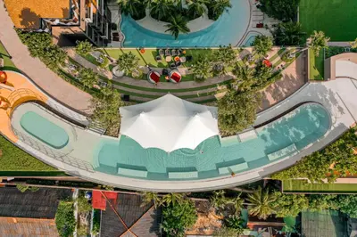 an overhead view of a resort swimming pool with an umbrella at The Marin Phuket Kamala Beach in Kamala Beach